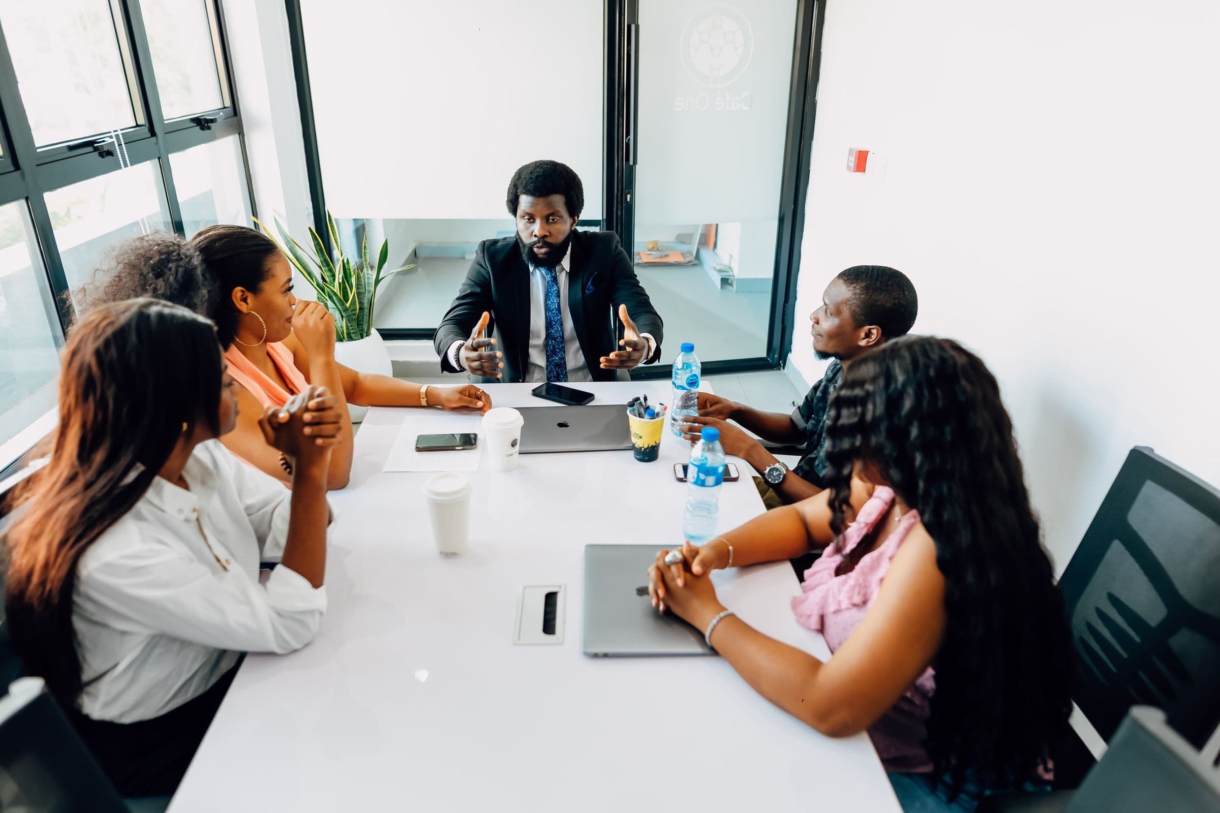 Executive leading a strategy session with his team around a boardroom table